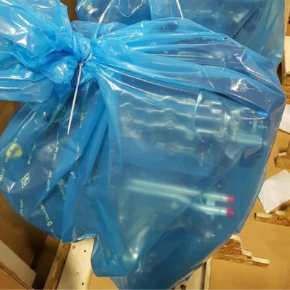 Two Cortec VpCI-126 Anti Rust bags containing metal parts. The bags have been closed with zip ties.