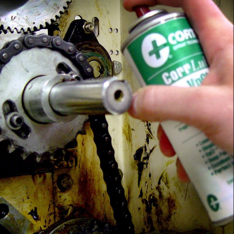 A metal chain being sprayed with Cortec VpCI Super Penetrant.