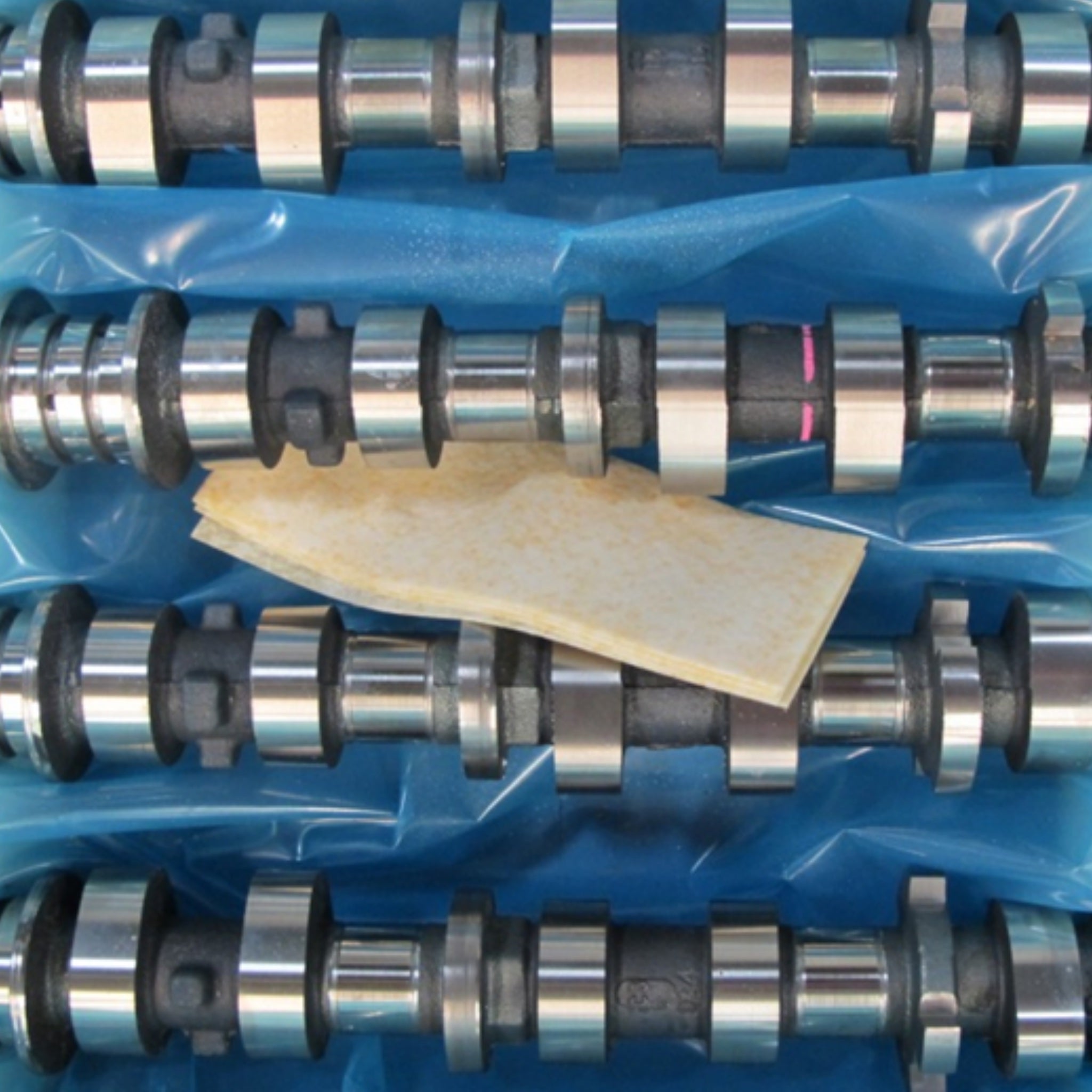 Automotive parts protected with VCI anti rust packaging showing VpCI-126 Blue film and a vci emitter.