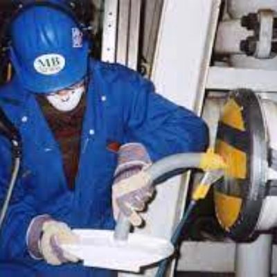 Worker applying Cortec VpCI-609 Anti Rust Powder.